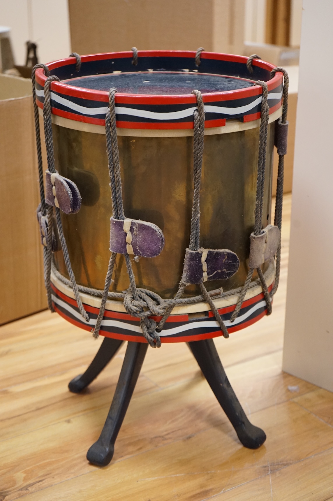 A red painted Regimental drum shaped table, 62cm high